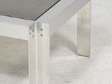 a glass table with a metal frame on it