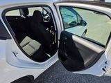 a white car with its door open sitting in a parking lot