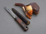 three different types of pipe and a knife on a table