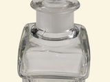 a clear glass bottle with a lid on a white background