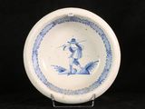 a blue and white plate with a bird on it