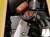 a cardboard box filled with cameras and other things