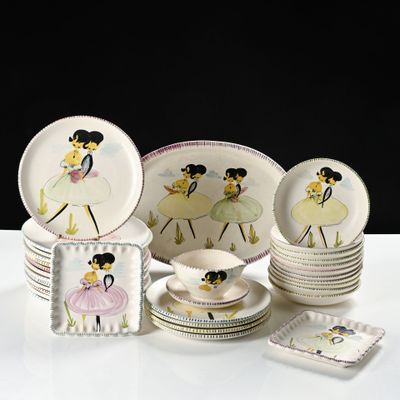 a lot of plates and cups that are on a table