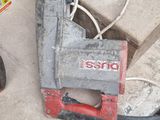 a red and black nail grinder sitting on a table