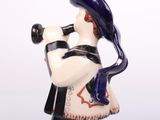 a figurine of a man playing a trumpet