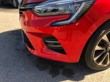 a close up of a red car parked in a parking lot