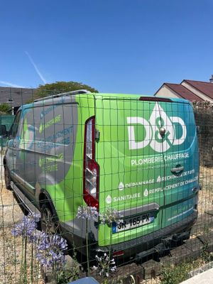 a green van that is parked in the yard