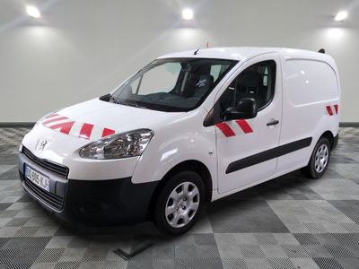 the white van is parked on a checkered floor in the garage