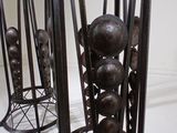 a lot of metal sculptures that are on display in a room