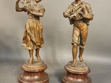 pair of antique bronze figurines of a boy and a girl
