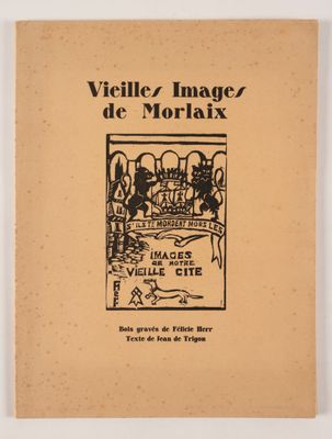 un vieux livre sur lequel figure l'image d'un village