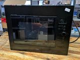 a microwave that is sitting on a table in a room