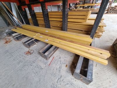 several pieces of wood are stacked on top of each other in a warehouse