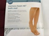 a picture of a close up of a person ' s foot on a bath mat