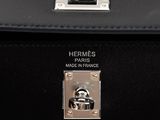 hermes ' s black leather handbag with a metal handle and metal latch