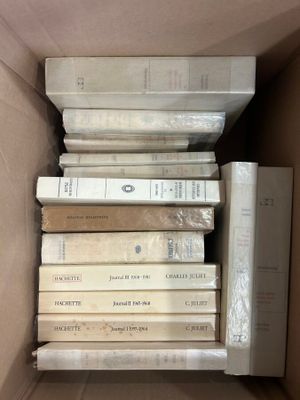 a box full of books that are stacked on top of each other