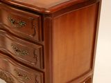 a wooden chest of drawers on a white background