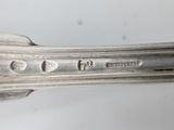 an image of a close up of a silver plate with a fork