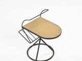 an image of a chair with a magazine rack on top of it
