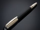 a black and gold pen on a black background