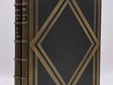 a black and gold book with a diamond design on the cover