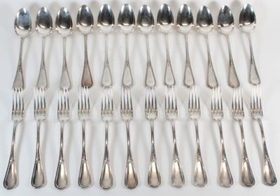 a lot of silver spoons and forks on the table