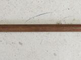 a wooden handle with a metal handle on a white surface