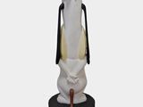 statue of a white rabbit with a hat on its head holding a cane