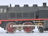 a black and red train engine on a white surface