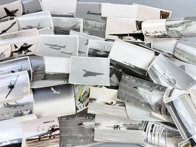 a pile of old photos of airplanes on a table