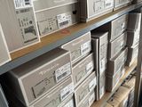 many boxes that are stacked on a shelf in a room