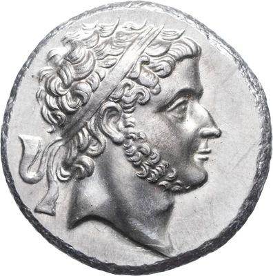 a close up of a coin with a man ' s head on it