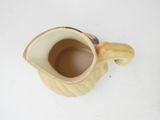 a creamer that is sitting on a white table