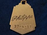 a picture of a gold medal with the name of a person