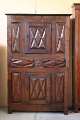 a wooden cabinet with a mirror on top of it
