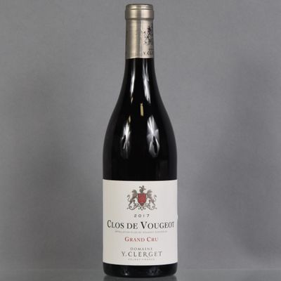 a bottle of red wine sitting on top of a table