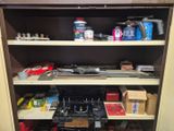 a shelf full of tools and other items in a room