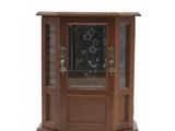 a small wooden corner cabinet with a glass door