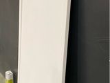 a white door leaning against a wall in a room
