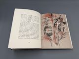 un livre ouvert sur lequel figure le dessin d'un homme