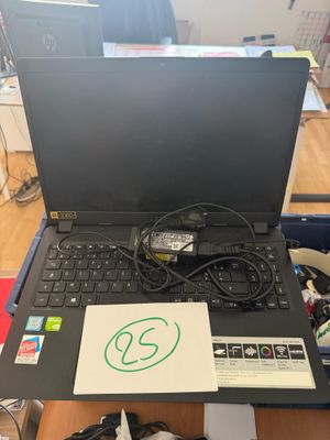 a laptop computer sitting on top of a wooden table