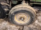 a tractor wheel that is sitting on the ground
