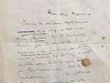 an old piece of paper with writing on it sitting on a table