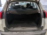the back of a car with its trunk open in a garage