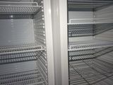 an empty refrigerator with a lot of shelves in it