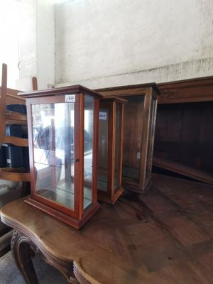 a glass case sitting on top of a wooden table