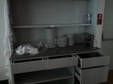 a shelf with dishes and cups on it in a room