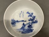 blue and white porcelain bowl with a scene of a man on a boat