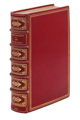 a red book sitting on top of a white surface