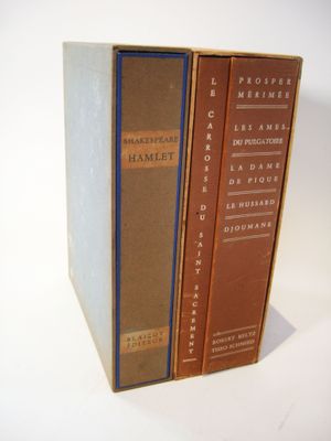three books are stacked on top of each other on a white surface